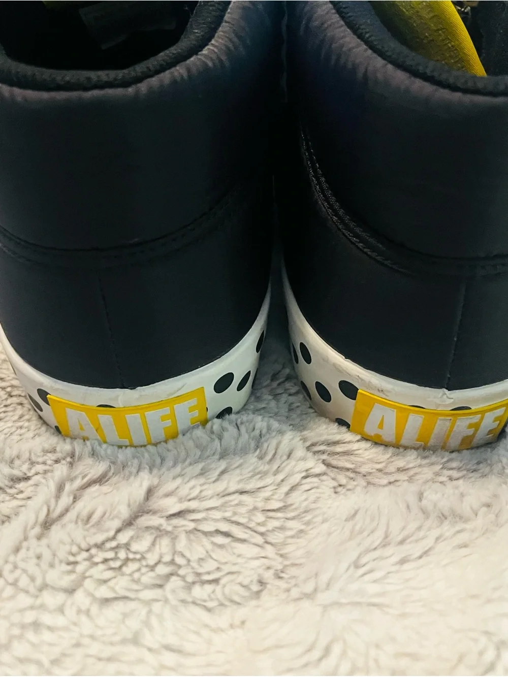 Alife Black High-Top Sneakers with Yellow Logo and White Polka Dot Laces